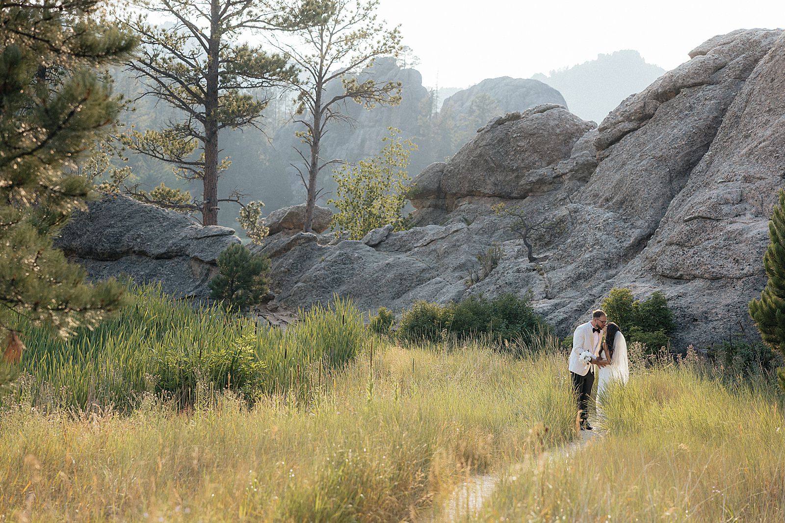 Phoebe and CJ kissing among the tall grasses