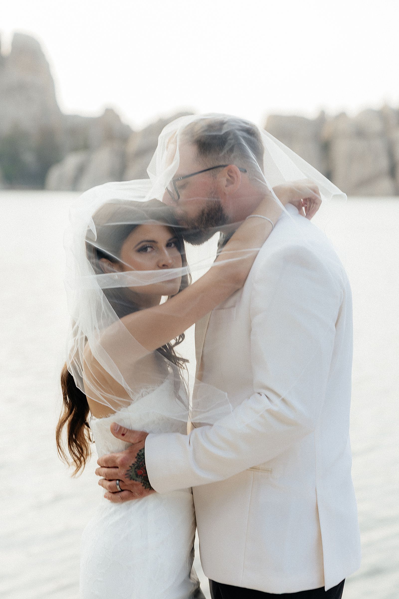 CJ and Phoebe under the veil at their elopement